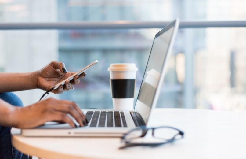 person using phone and computer