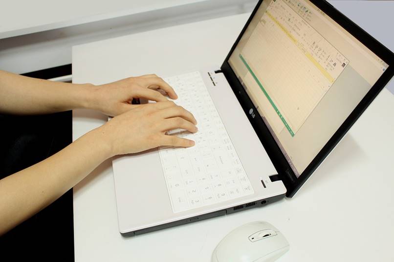 man typing on computer