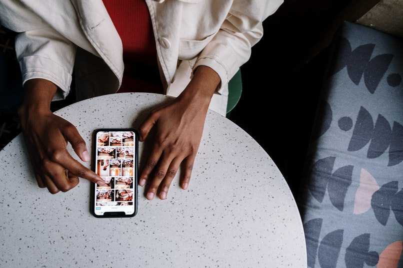 person raising or lowering the volume of the phone