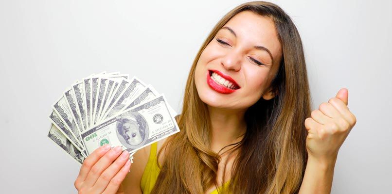 smiling girl holding dollars