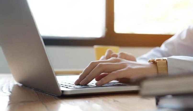 woman typing on laptop