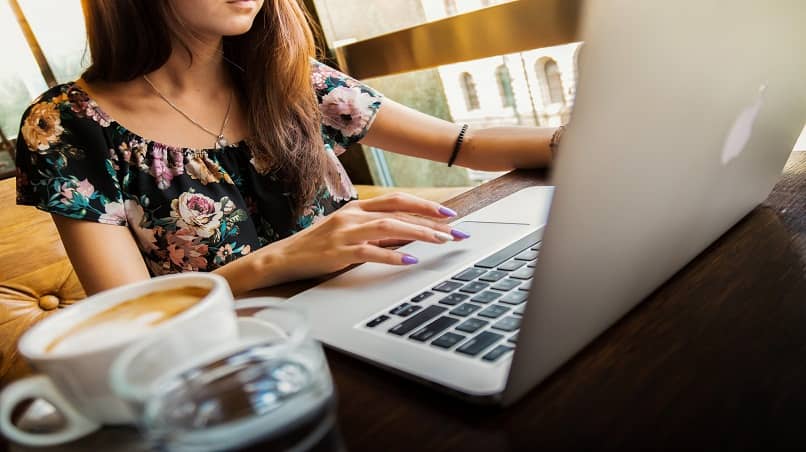 woman using mac laptop