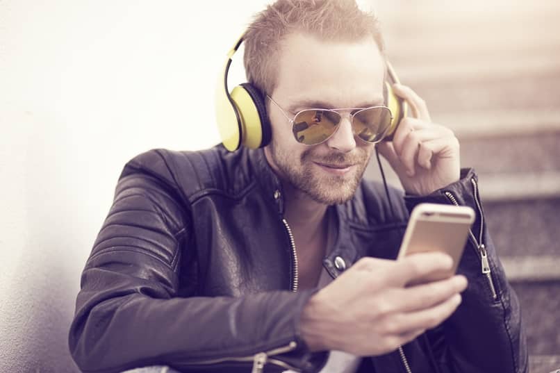 person using mobile phone with headphones