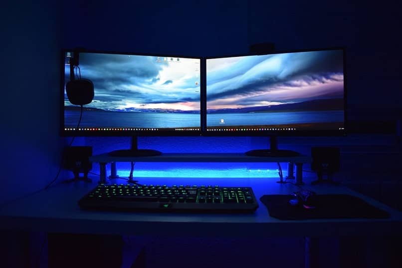 Two monitors on a table on a blue background