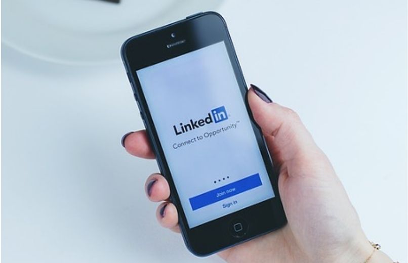 woman using linkedin on phone