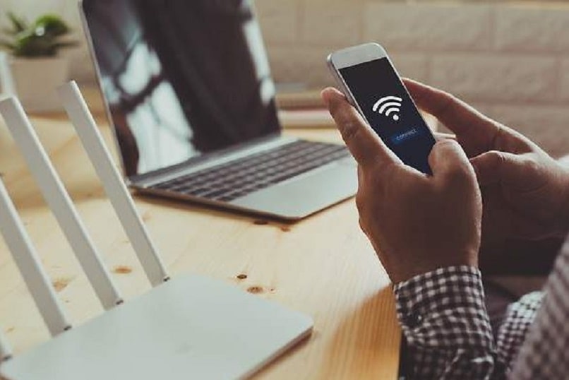 Man evaluating wifi sign on his mobile phone