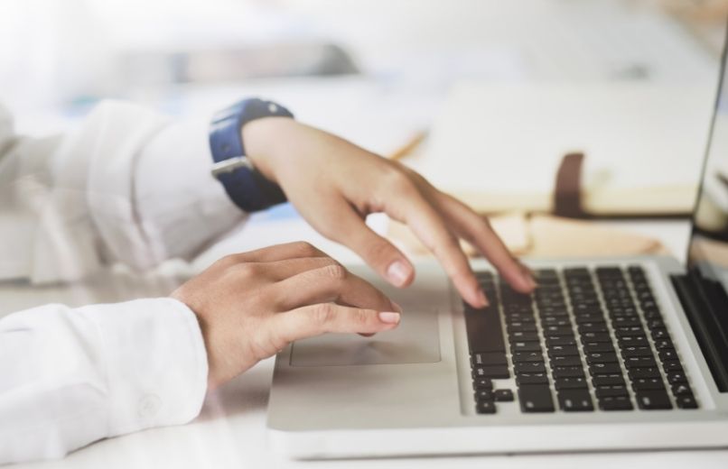 man typing on laptop