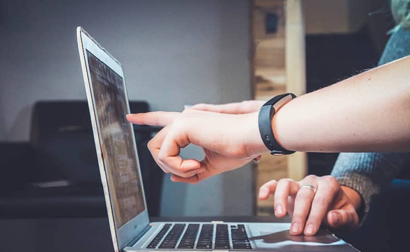 man pointing at his computer screen