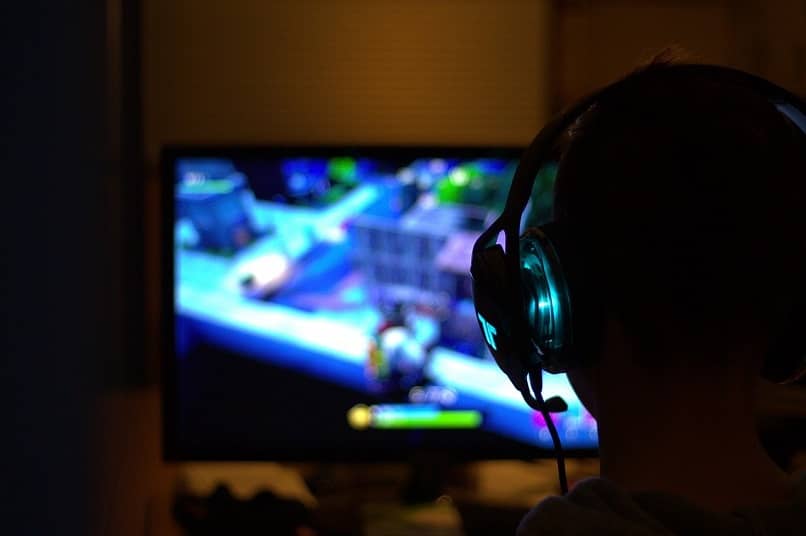 child with headphones playing video games