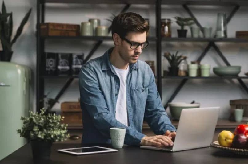 man using laptop at table