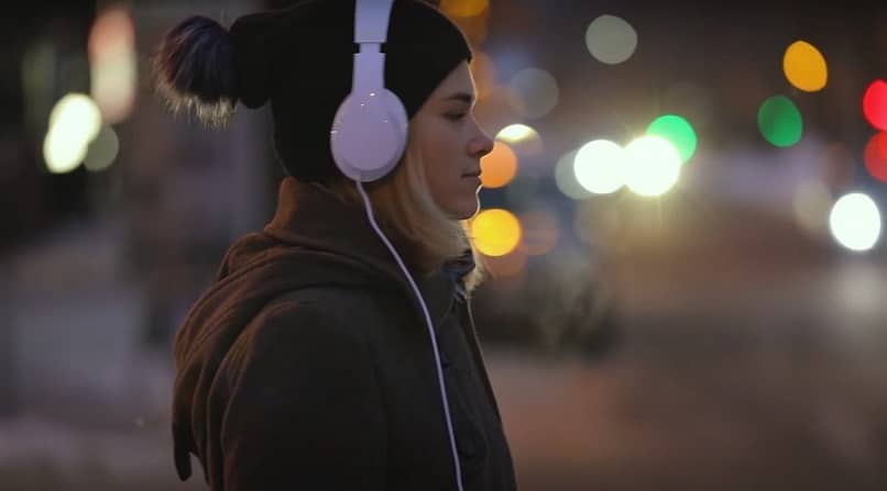 Young man listening to music with headphones