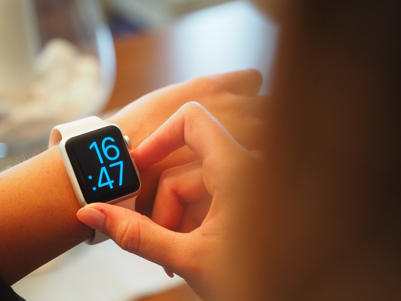 man looking at time on clock